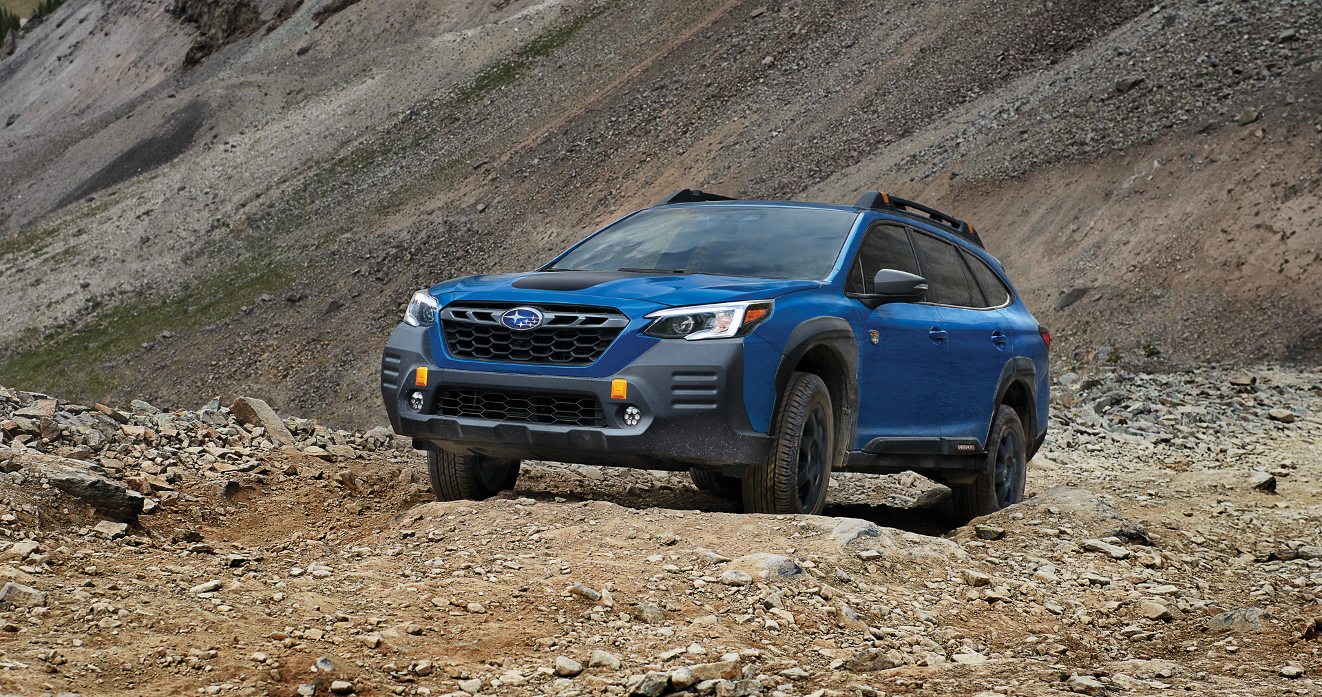 A 2023 Outback Wilderness driving on a trail in the mountains. | John Kennedy Subaru in Plymouth Meeting PA